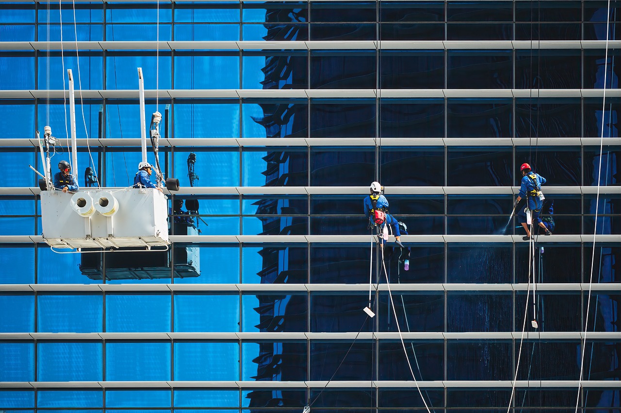 workers — windows — building — cleaners — cleaning — service — maintenance — crane cradle — glass — reflection — high-rise bu